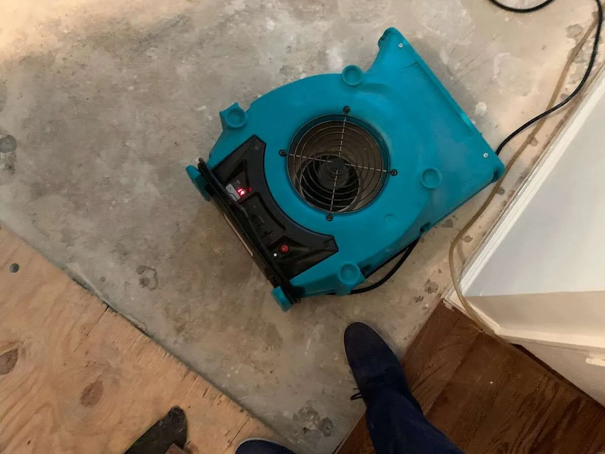 Air mover drying subfloor during Commercial Water Damage Restoration in Rolesville